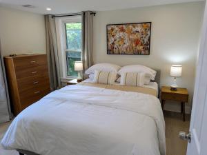 a bedroom with a large white bed with two pillows at Modern Comfort in Marlborough +9 photos