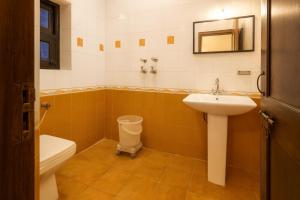 a bathroom with a sink and a toilet at Oslo Green By Around Stays, Tapovan, Rishikesh in Rishīkesh +34 photos