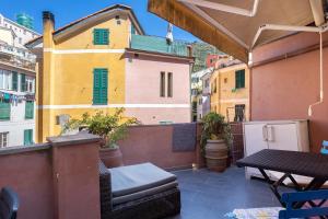 a balcony with a table and some buildings at Lisettarooms in Vernazza