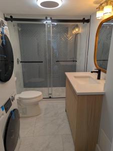 a bathroom with a shower and a toilet and a sink at Modern Comfort in Marlborough