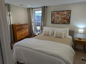 a bedroom with a large white bed and a window at Modern Comfort in Marlborough