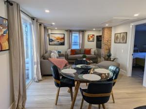 a living room with a table and chairs at Modern Comfort in Marlborough