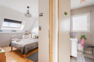 a small bedroom with a bed and a window at Les chambres de Florence in Saint-Jouan-de-lʼIsle