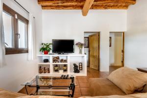 a living room with a couch and a glass table at Can Marsá de Baix in Santa Eularia des Riu