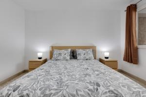 a bedroom with a large bed with two night stands at Edificio El Baifo Loco - Milena in Gran Tarajal