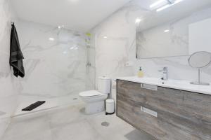 a bathroom with a toilet and a tub and a sink at Edificio El Baifo Loco - Milena in Gran Tarajal +18 photos