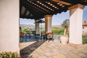 a patio with a table and chairs and a view at Maravida Vacation Rooms in Dobrovo