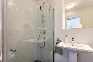 a bathroom with a shower and a sink at Terralpin Apartments - 27qm in Bruckmühl +10 photos