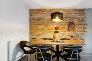 a dining room with a brick wall and a table with chairs at Felicitas in Tann +13 photos