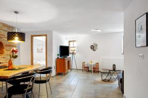 a living room and dining room with a table and chairs at Felicitas in Tann