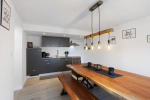 a kitchen and dining room with a wooden table at Fewo Kerbe in Willingen