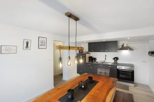 a kitchen with a wooden table in a room at Fewo Kerbe in Willingen +12 photos