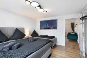 a bedroom with a large bed with a gray comforter at Fewo Kerbe in Willingen
