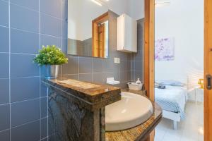 a bathroom with a sink and a mirror at Villa Clara in Gallina +30 photos