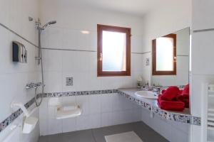 a white bathroom with a sink and a mirror at Maison Iris in Castelnaud La Chapelle +16 photos