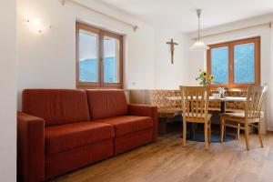 a living room with a couch and a table at Thusnelda Apartment D in Siusi