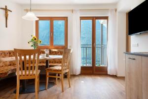 a kitchen and dining room with a table and chairs at Thusnelda Apartment D in Siusi +23 photos