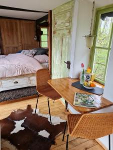 a bedroom with a bed and a wooden table and chairs at Pepper Huis in Lemgo