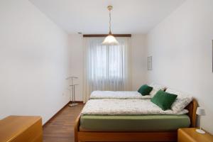 a bedroom with two beds and a window at Apartment Bossi View in Chiavenna