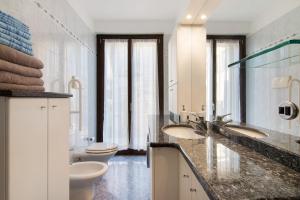 a bathroom with two sinks and two toilets at Apartment Bossi View in Chiavenna +19 photos