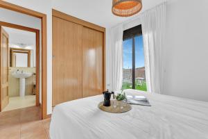 a bedroom with a bed and a large window at Villa Asensio in Lajares
