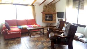 a living room with a couch and a table and chairs at Cortijo la Era in Castril
