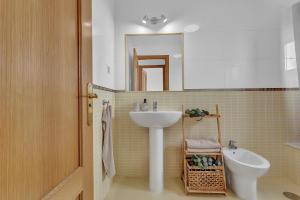 a bathroom with a sink and a toilet at Villa Asensio in Lajares +25 photos