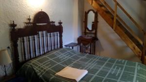 a bedroom with a bed with a green comforter at Cortijo la Era in Castril +14 photos