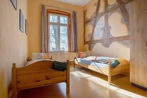 a bedroom with two beds and a window at Gutshaus Meerzauber in Altenkirchen