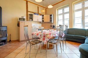 a kitchen and dining room with a table and chairs at Gutshaus Meerzauber in Altenkirchen