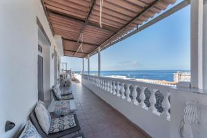 a balcony with chairs and a view of the ocean at Welcome To The Relax Zone in Los Caideros