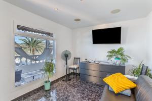 a living room with a couch and a window at Welcome To The Relax Zone in Los Caideros