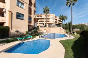 a swimming pool in front of a apartment building at Penthouse 3-bedroom duplex in Mijas
