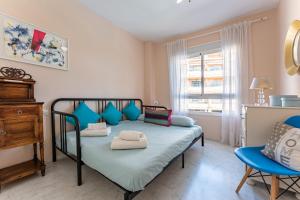 a bedroom with a bed and a chair and a window at Penthouse 3-bedroom duplex in Mijas +16 photos