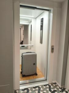 a suitcase is sitting in the hallway of a room at Strettorooms in Villa San Giovanni