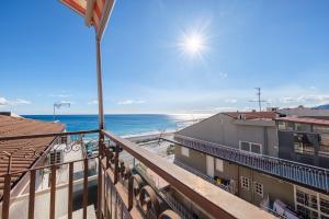 a balcony with a view of the beach at Lumeriam Sea Loft in Roccalumera