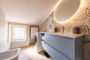 a bathroom with a sink and a toilet and a sink at Lumeriam Sea Loft in Roccalumera