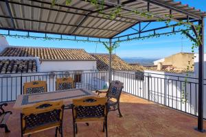 a patio with a table and chairs on a balcony at Casa Romo 2 in Rute