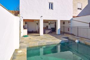a house with a swimming pool in front of a house at Casa Romo 2 in Rute