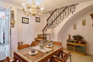 a dining room with a table and a chandelier at Casa Romo 2 in Rute