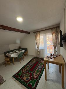 a living room with a table and a dining room at Bugojno Avantura in Donjići +19 photos