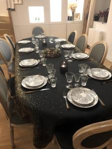a long table with plates and glasses on it at Moulin De La Benatre in Entrammes +23 photos