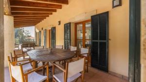 a dining room with a wooden table and chairs at Son Aladern in Islas Baleares