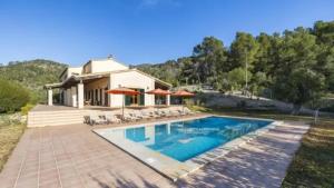 a house with a swimming pool in front of a house at Son Aladern in Islas Baleares