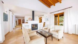 a living room with white furniture and a fireplace at Son Aladern in Islas Baleares