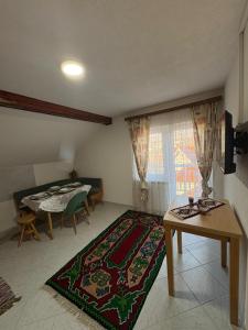 a living room with a table and a dining room at Bugojno Avantura in Donjići