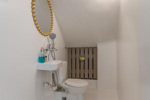 a bathroom with a toilet and a sink at A Tinian Room 4 in Tinos