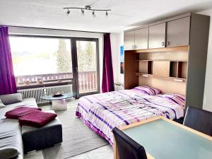 a bedroom with a bed and a table in it at Ferienpark Oberallgäu Haus 1 in Missen-Wilhams +28 photos