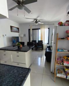 a kitchen and living room with a ceiling fan at על הים in Nahariyya