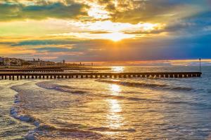 a sunset over the ocean with a pier at Euroholiday Village 3G in Lido di Jesolo +2 photos